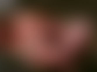 A newborn baby lying in a blanket with umbilical cord attached