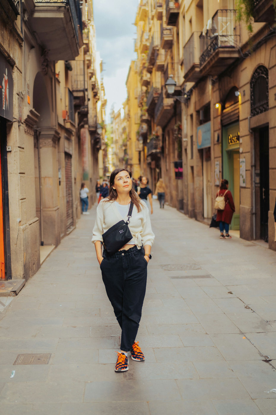 Solo female traveler walking through the city streets in Spain