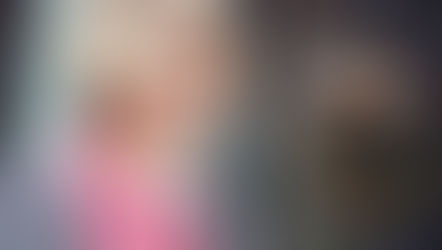 A woman in her 40s with a natural smile photographed in soft warm light, representing perimenopause oral health and the impact of hormonal changes on teeth and gums from Vibrance Way.