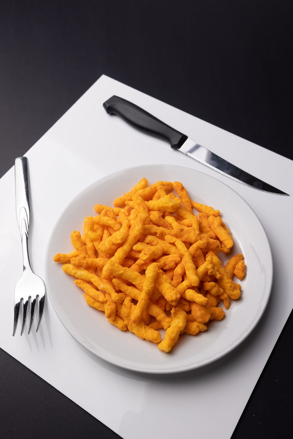 White plate of cheese puff corn snacks
