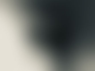 Blurred portrait of a person in grayscale, with motion effect creating a dreamy, mysterious mood. Dark background enhances the ethereal feel.