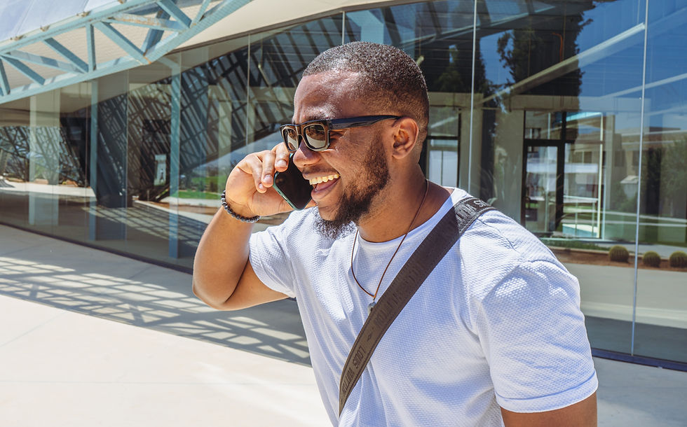 Smiling person talking on a smartphone during a casual phone conversation