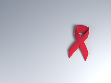 Single red cancer ribbon on a gray background