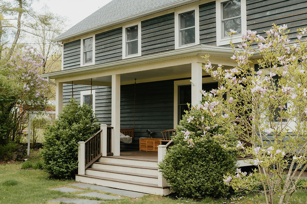 House with a front porch and landscaped yard