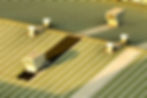 An elevated close-up of an industrial corrugated metal commercial building roof fitted with vents, illustrating the specialized low-slope and energy-efficient commercial roofing solutions serviced by Central Roofing Inc.