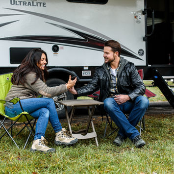 Couple playing a game at an RV campsite