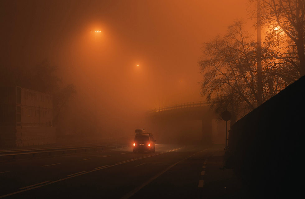Car driving through a dense fog