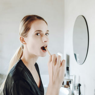 young lady brushing her teeth