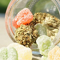 Cannabis buds with gummy candies in a jar