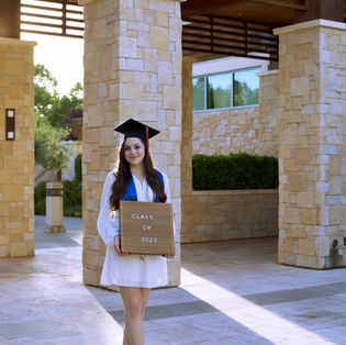 A student in academic dress on graduation day