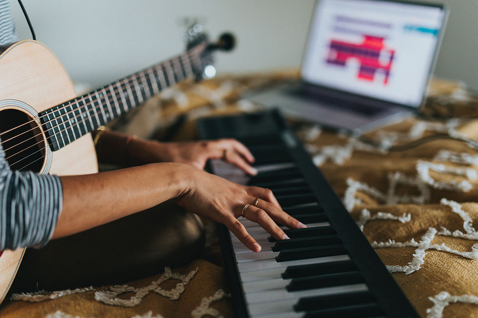 songwriter composing a song at keyboard