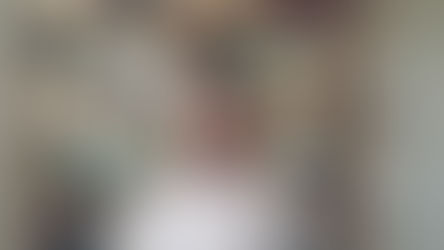 shocked woman standing in front of a shelf of plants