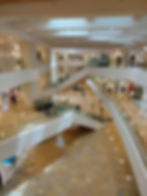 overhead view of the interior of a shopping mall with escalators and corridors