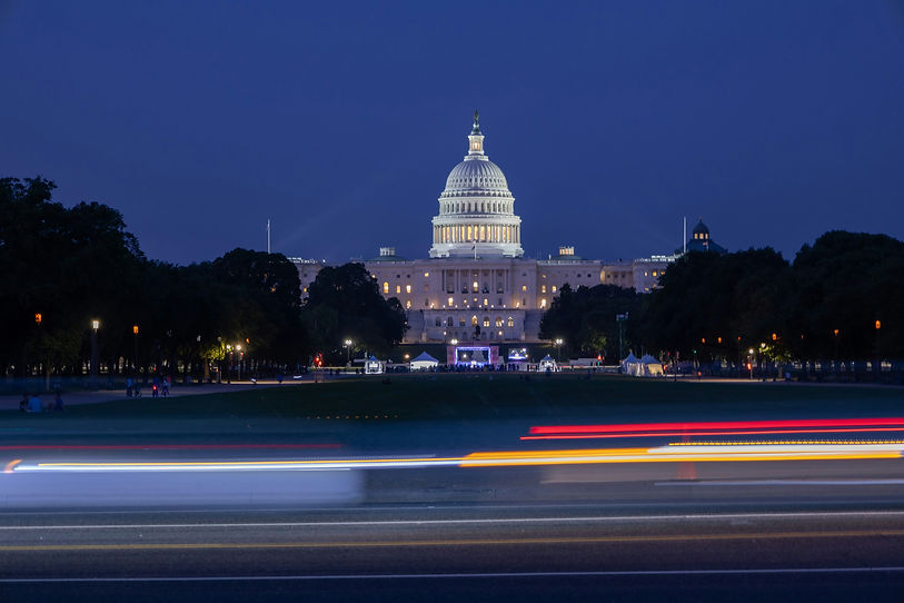 U.S. Capitol at dusk with traffic light trails