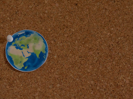 World map pinned to cork board