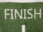 Finish line on green turf symbolizing end of lease term or rental agreement period