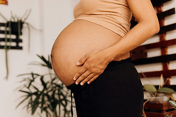 Pregnant woman experiencing pelvic girdle pain while standing during pregnancy