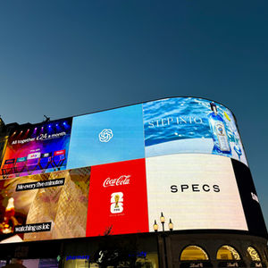 Brightly lit digital billboards at night.