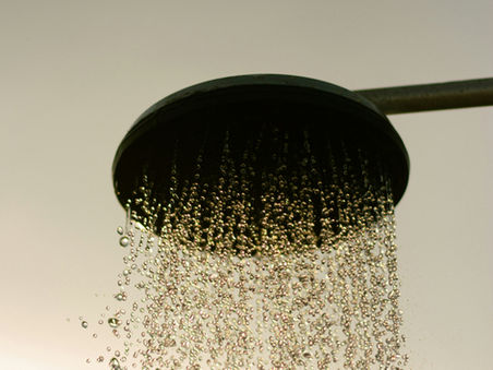 Shower head with running water symbolizing golden showers