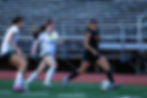 Adolescent girls playing competitive soccer