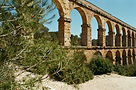 Roman aqueduct arches in warm natural light