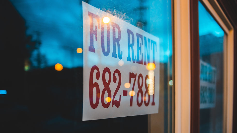 For rent sign with a phone number, displayed on a glass door. Reflections and a blue evening sky create a calm mood.