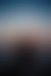 A silhouetted hand waves farewell to August as the sun sets over the tranquil lake Michigan, marking the end of summer days.