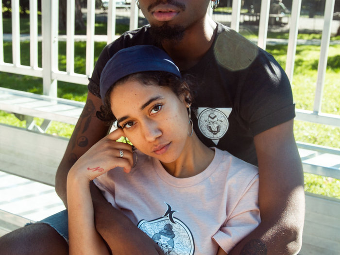 Young couple sitting close together on a porch
