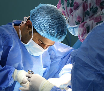 podiatric doctor performing ankle surgery on a patient with foot pain