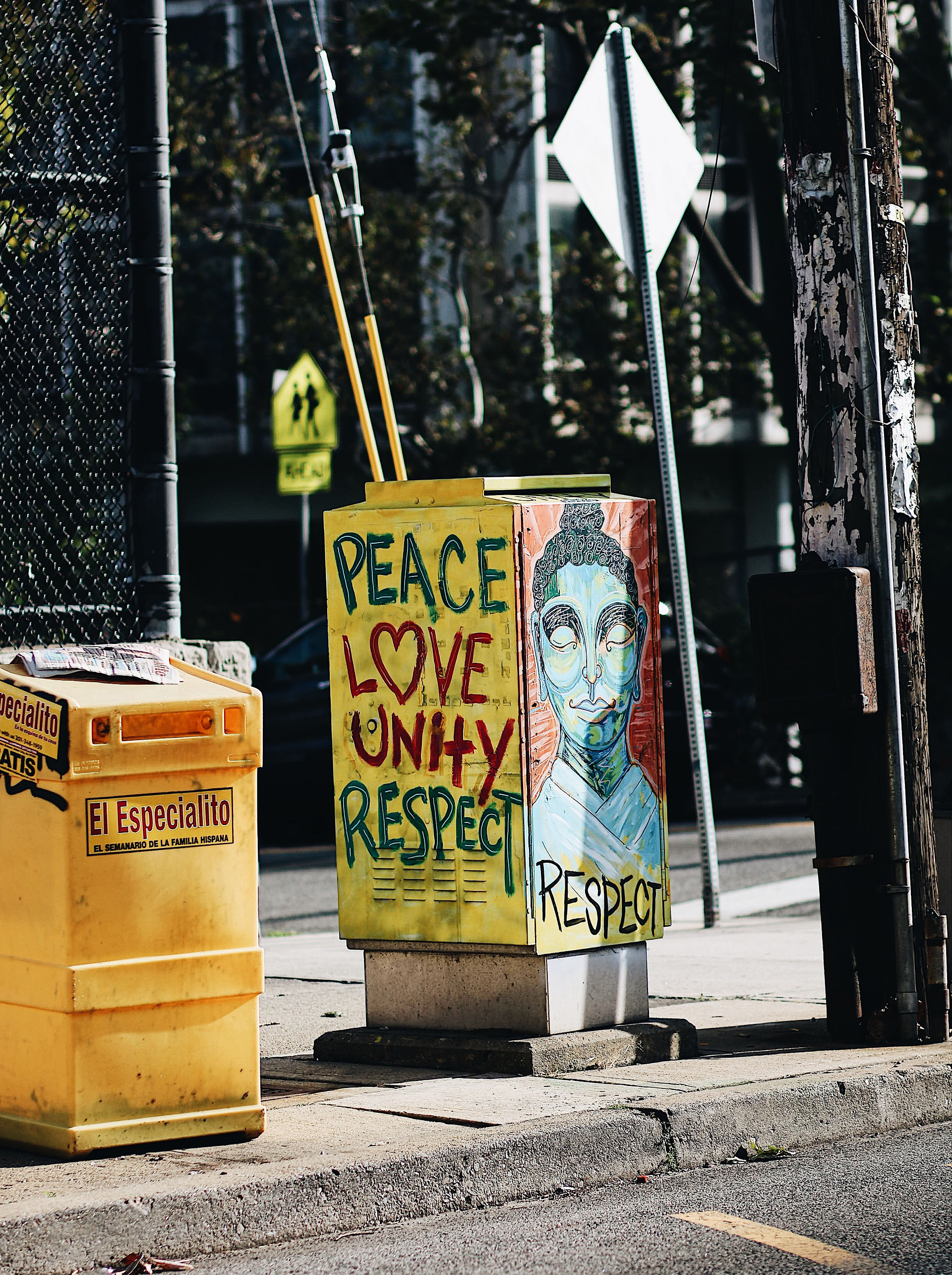 peace, love, unity, respect painted on a metal street box