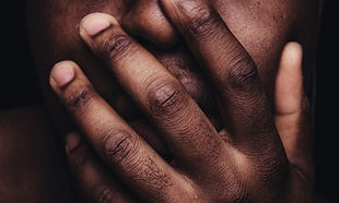 Image of man's hand over his mouth