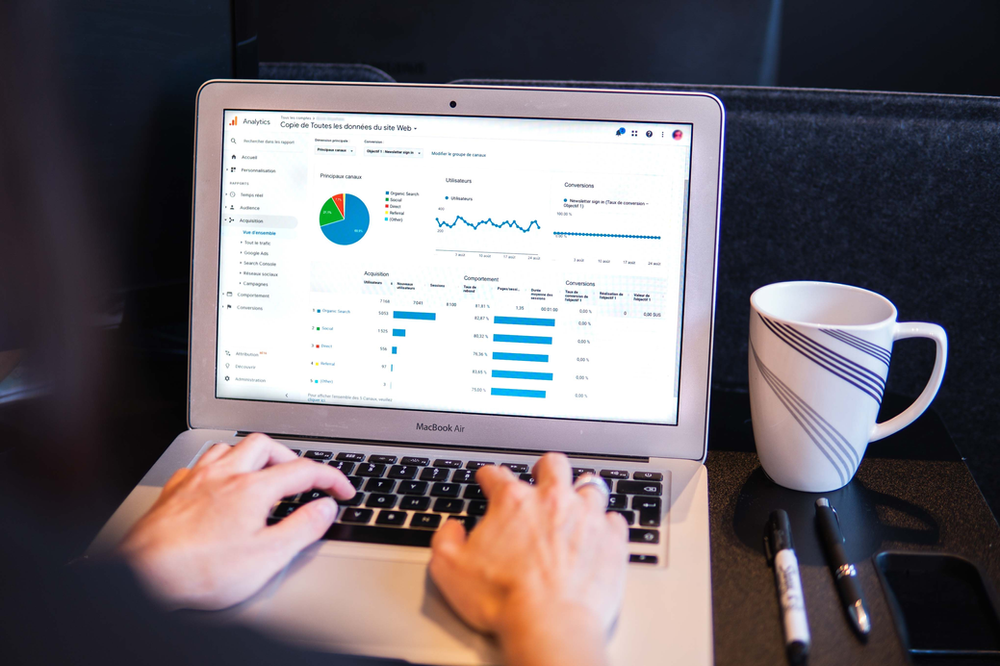 An anlytics dashboard showing in the laptop screen