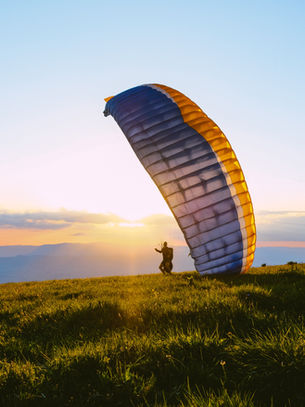Pilot inflating a paraglider