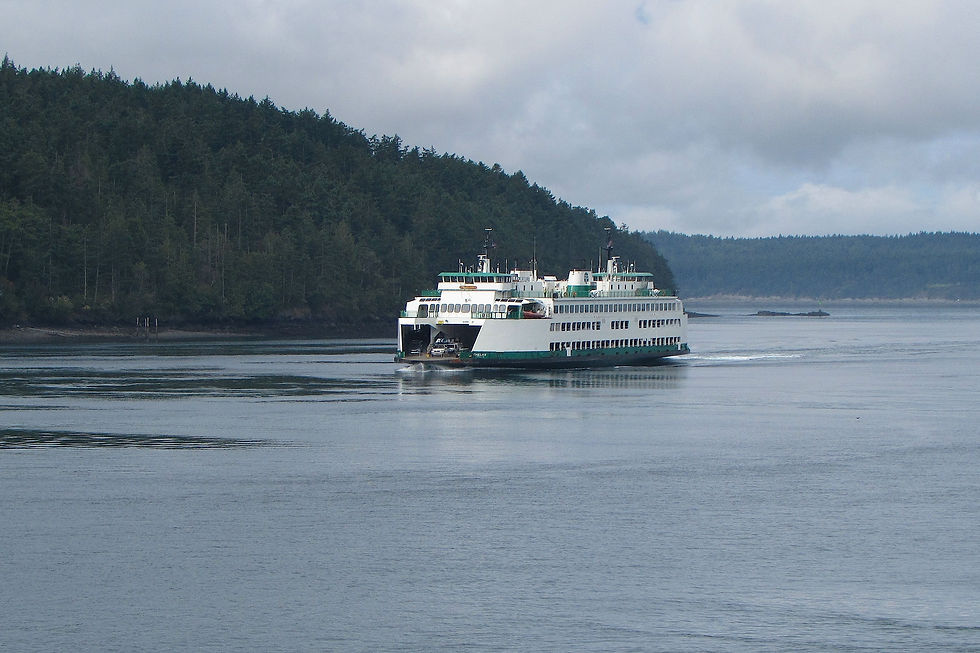 Washington State Ferry crossing Puget Sound at sunset with Olympic Mountains in the background