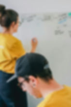 Colleagues collaborating on a strategy whiteboard