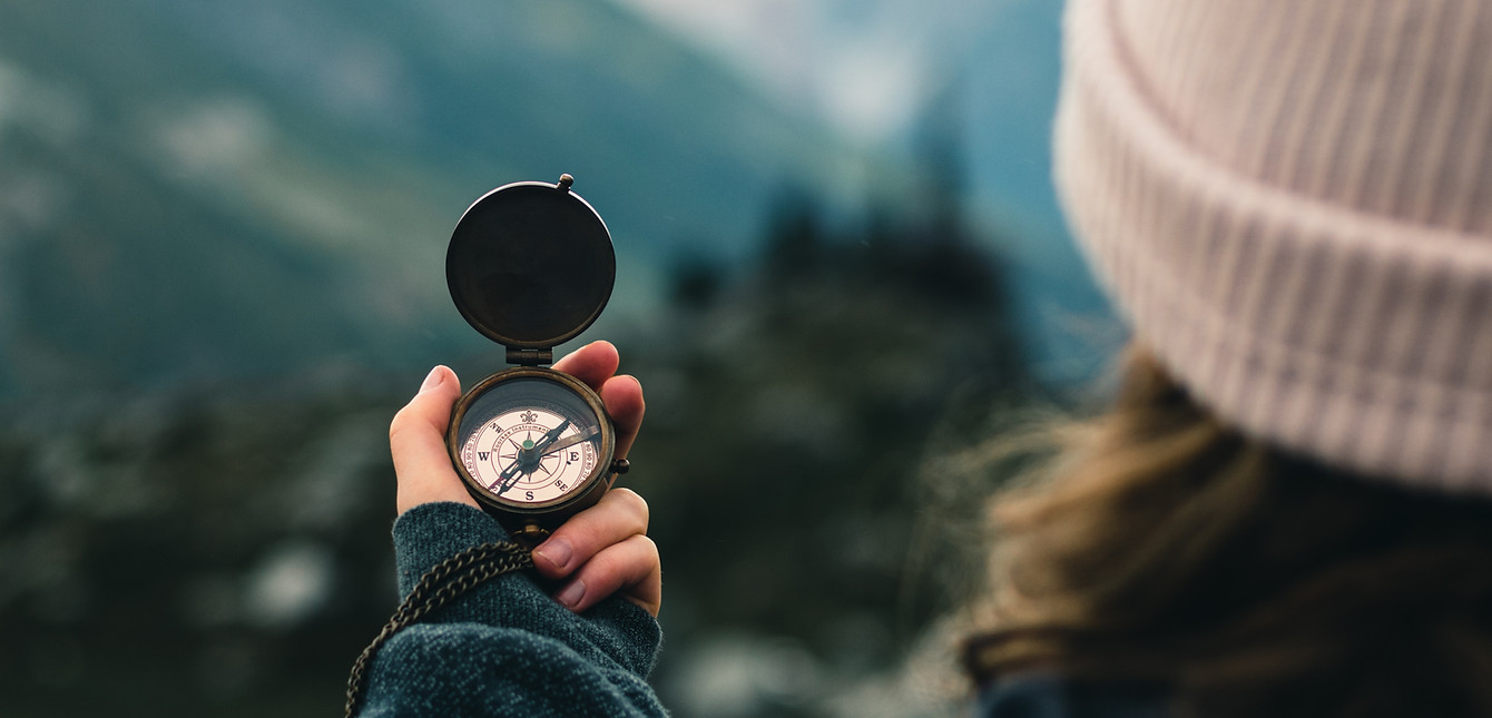 Woman finding direction in life with a compass