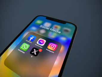A smartphone screen shows a Social Media folder with icons for Facebook, Instagram, X, etc.