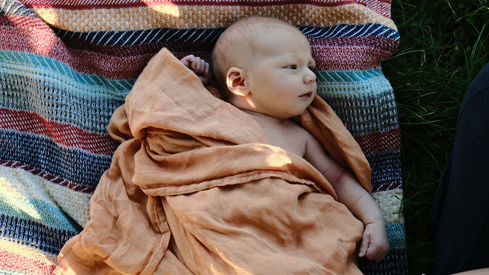 baby lying on blanket