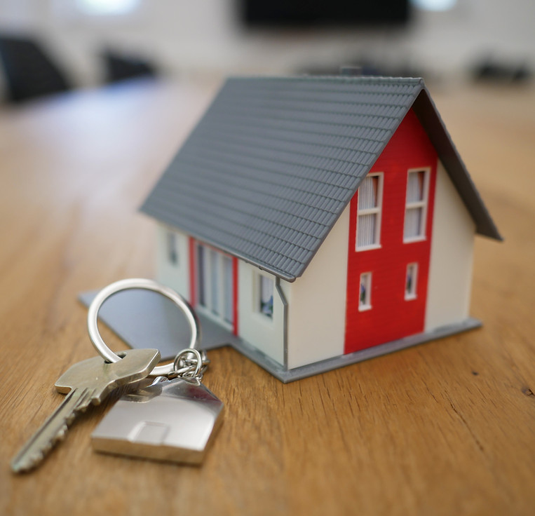 Small model house and keys for real estate investors.