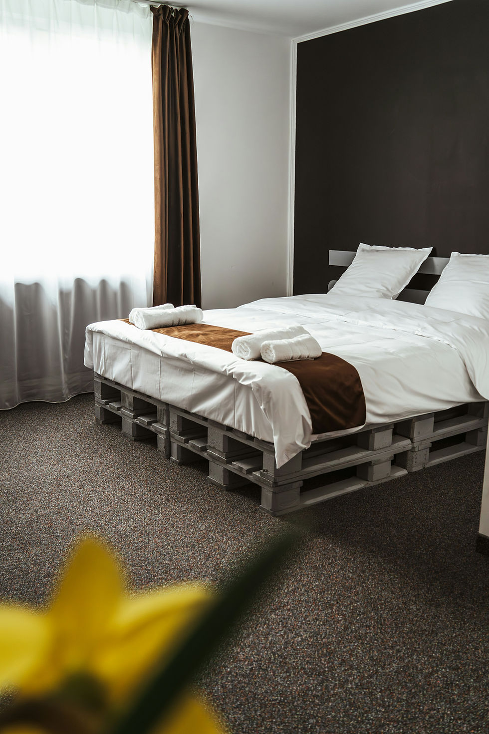Clean bedroom with pallet bed, reliable house cleaning result