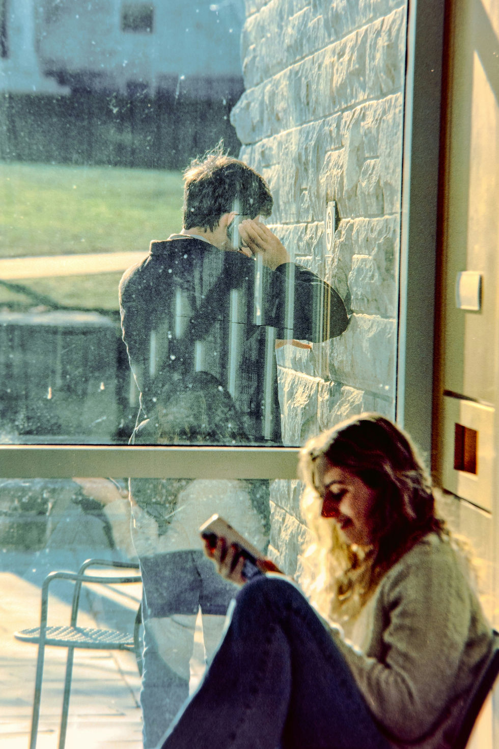 Woman sitting by a window in quiet reflection.