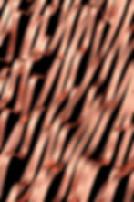 A wavy copper metal slatted sheet.