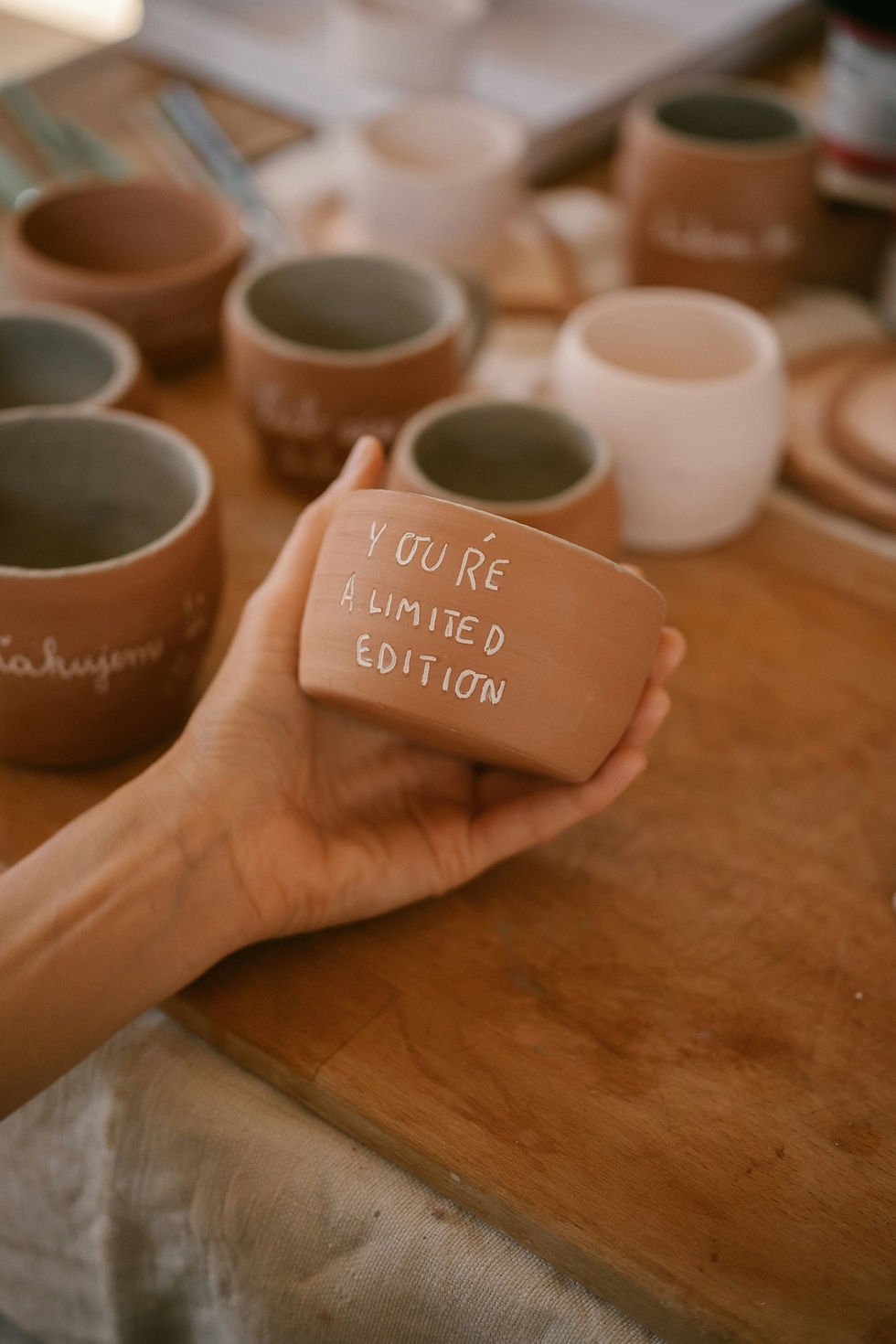 Person shaping clay at a pottery date night in London