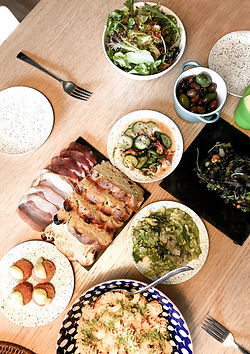 A delicious meal with bread, meats, and salad.
