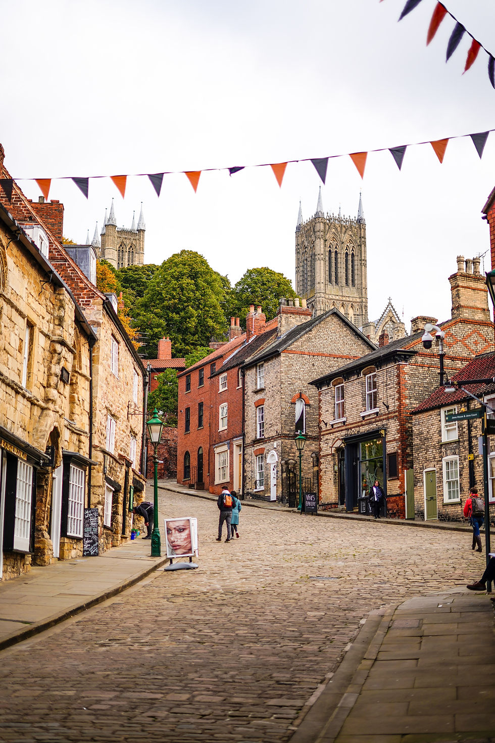 English village centre with bunting flags hanging high above the street