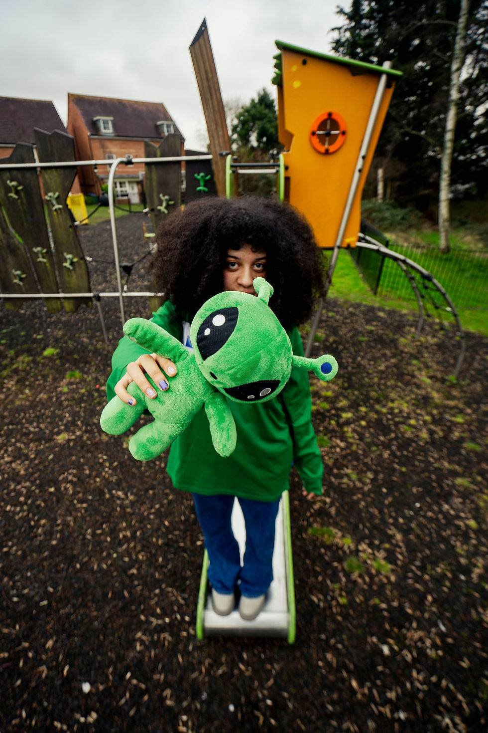 Image of a person holding an alien stuffed toy.