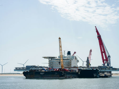 Offshore wind installation vessel beside turbines under construction at sea
