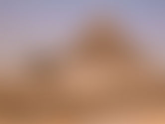 A calm view of the pyramids of Giza at sunset showing the timeless Wonders of Egypt.