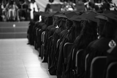 People in caps and gowns at a graduation ceremony