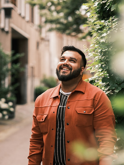 A South Asian man smiling